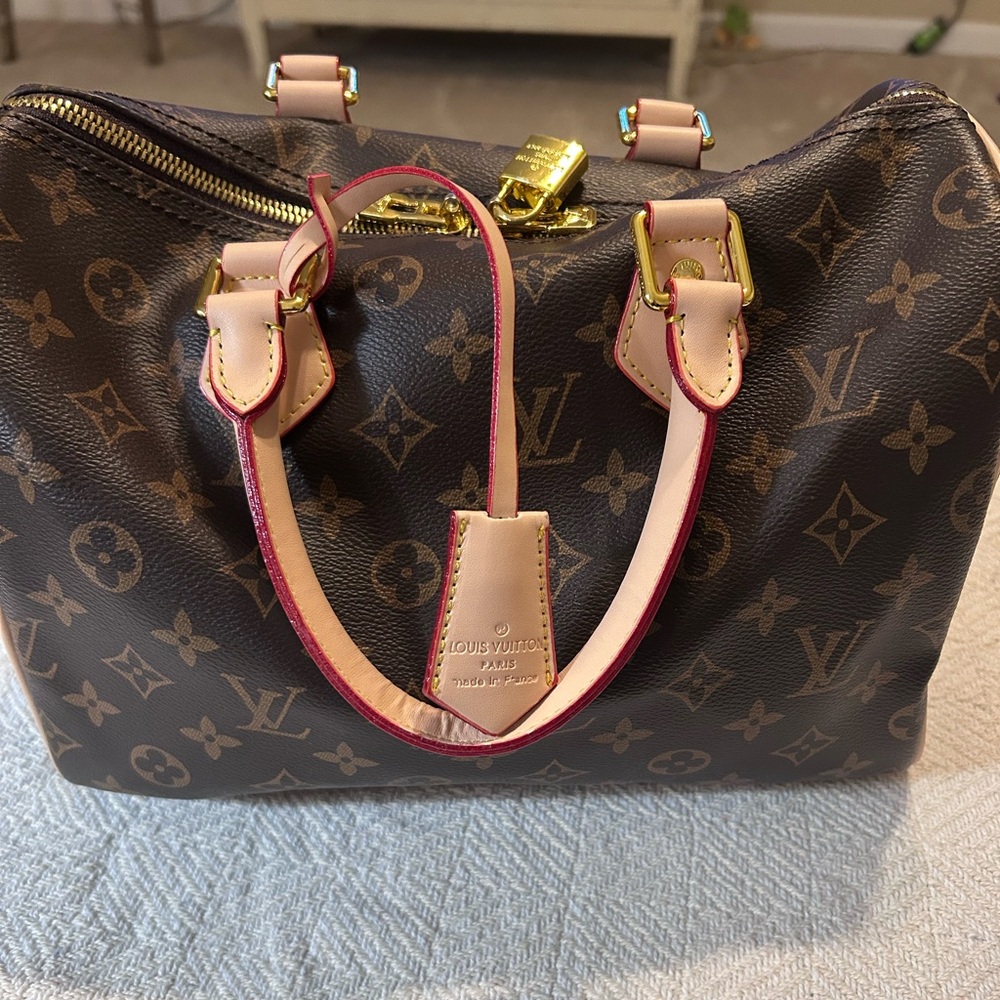 Speedy 30. Signature monogram, brown/tan. Inside is red and black stripped.